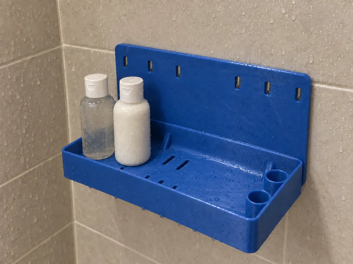 A blue printed shower caddy with a six-slot backplate and two brush sleeves holds plain bottles against wet tiles
