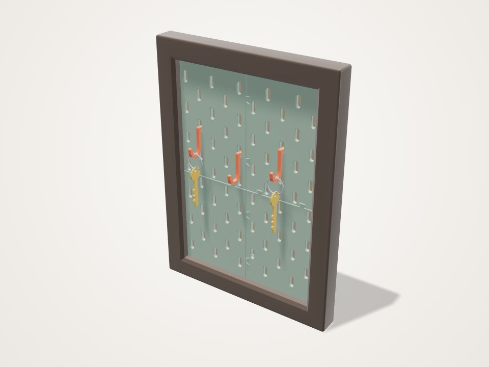 Dark picture frame filled with a green slotted pegboard, with orange hooks holding two keys